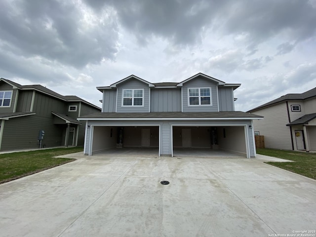 traditional home featuring concrete driveway and a garage