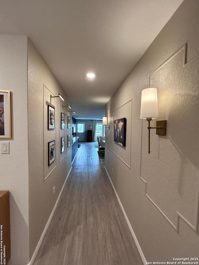 5936 Forenoon, Bulverde, TX 78163 - hallway featuring a textured wall, dark wood-style floors, and baseboards