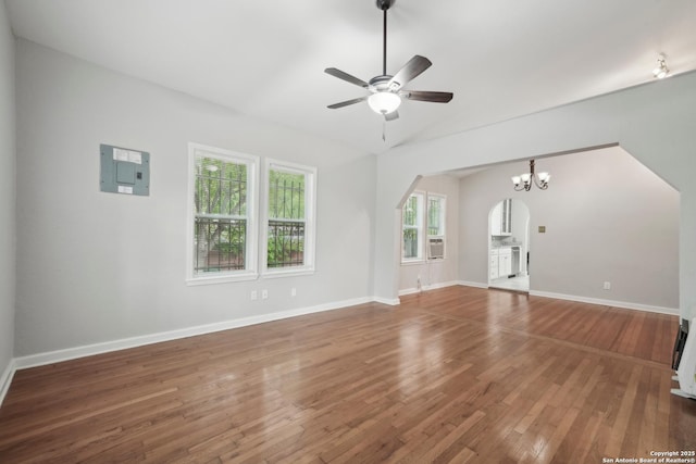 1923 W Pyron Ave, San Antonio, TX 78211 - unfurnished living room with electric panel, vaulted ceiling, arched walkways, wood finished floors, and ceiling fan with notable chandelier