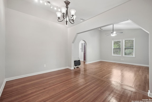 1923 W Pyron Ave, San Antonio, TX 78211 - empty room with heating unit, baseboards, arched walkways, wood finished floors, and ceiling fan with notable chandelier