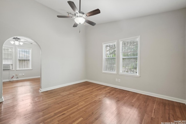 1923 W Pyron Ave, San Antonio, TX 78211 - spare room with light wood-style flooring, arched walkways, baseboards, a towering ceiling, and a ceiling fan
