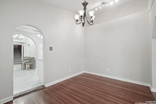 1923 W Pyron Ave, San Antonio, TX 78211 - unfurnished dining area with wood finished floors, arched walkways, a chandelier, baseboards, and stairway