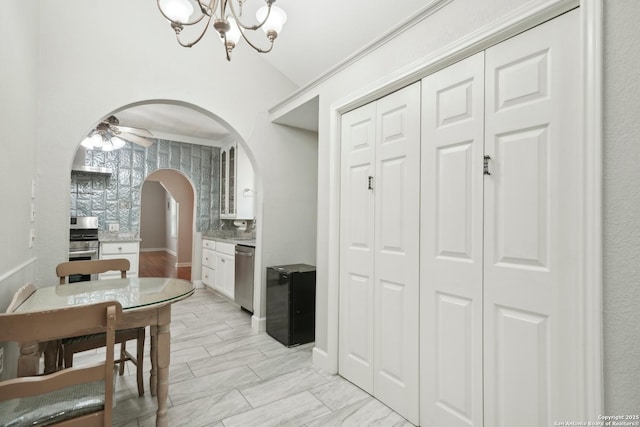 1923 W Pyron Ave, San Antonio, TX 78211 - dining room featuring arched walkways, ceiling fan with notable chandelier, and lofted ceiling