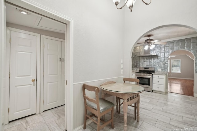 1923 W Pyron Ave, San Antonio, TX 78211 - dining space featuring ceiling fan, wainscoting, and arched walkways