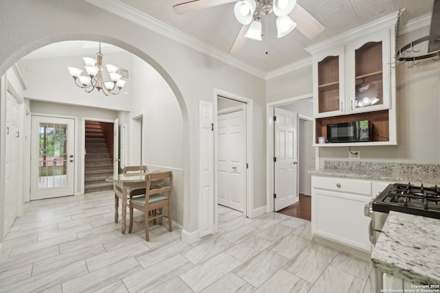1923 W Pyron Ave, San Antonio, TX 78211 - dining space with ornamental molding, ceiling fan with notable chandelier, stairs, and arched walkways