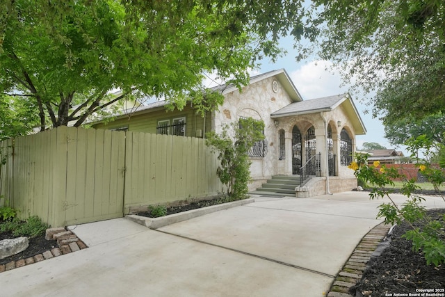 1923 W Pyron Ave, San Antonio, TX 78211 - rear view of property featuring fence and stone siding