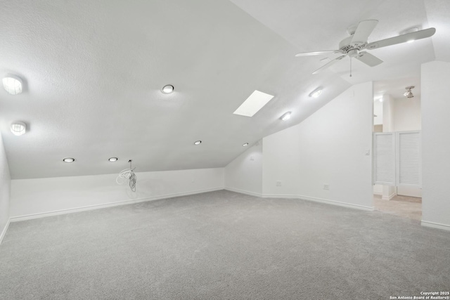 1923 W Pyron Ave, San Antonio, TX 78211 - additional living space featuring a ceiling fan, vaulted ceiling with skylight, carpet floors, and baseboards