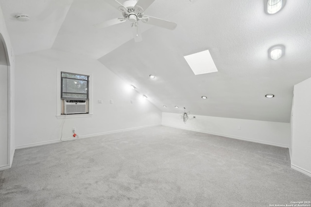 1923 W Pyron Ave, San Antonio, TX 78211 - additional living space featuring baseboards, cooling unit, carpet floors, and lofted ceiling with skylight