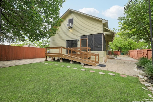 1923 W Pyron Ave, San Antonio, TX 78211 - rear view of property with a patio, a wooden deck, a sunroom, a fenced backyard, and a lawn