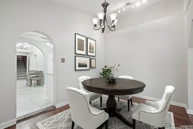 1923 W Pyron Ave, San Antonio, TX 78211 - dining space with a chandelier, baseboards, arched walkways, wood finished floors, and stairs