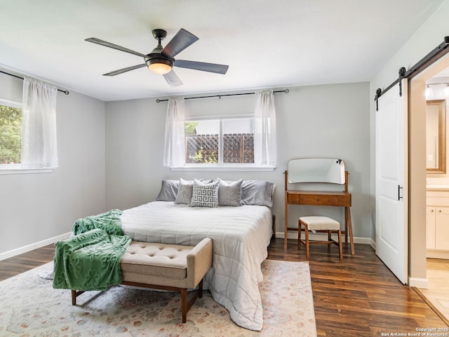 106 Castleoaks Dr, San Antonio, TX 78213 - bedroom featuring baseboards, a barn door, wood finished floors, and connected bathroom
