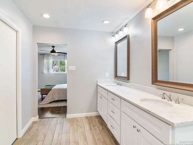 106 Castleoaks Dr, San Antonio, TX 78213 - bathroom with a sink, ceiling fan, double vanity, baseboards, and wood finished floors