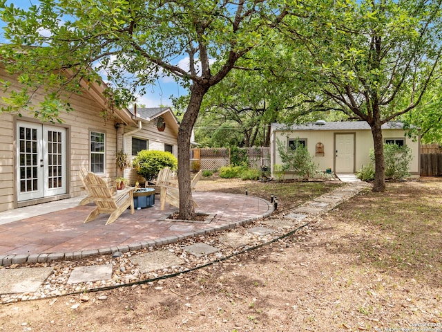 106 Castleoaks Dr, San Antonio, TX 78213 - view of yard with a patio, an outdoor structure, a fire pit, french doors, and fence