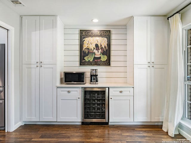 106 Castleoaks Dr, San Antonio, TX 78213 - bar with stainless steel microwave, recessed lighting, dark wood-style floors, wine cooler, and visible vents