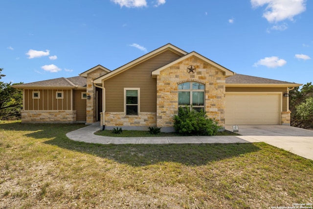 ranch-style house with a garage, stone siding, a front lawn, and concrete driveway
