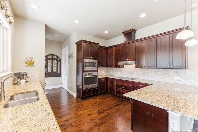 kitchen with light stone countertops, stainless steel appliances, dark wood-style floors, and a sink