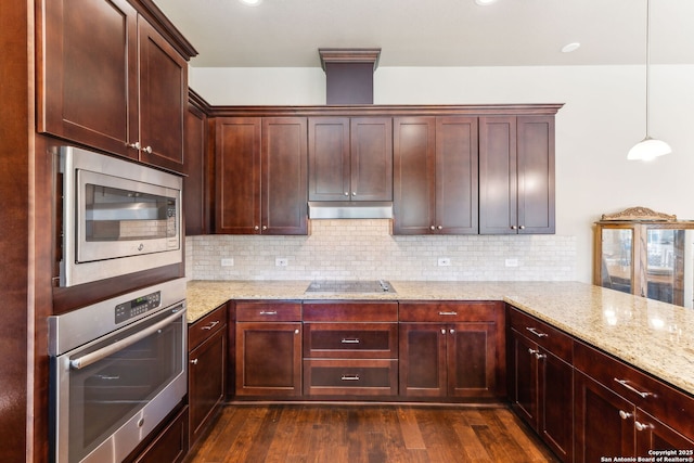kitchen with dark wood-style flooring, tasteful backsplash, light stone countertops, under cabinet range hood, and appliances with stainless steel finishes