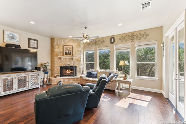 living area featuring recessed lighting, visible vents, a ceiling fan, dark wood-type flooring, and a fireplace