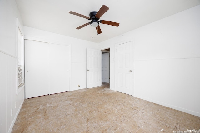 unfurnished bedroom with ceiling fan, baseboards, and a closet