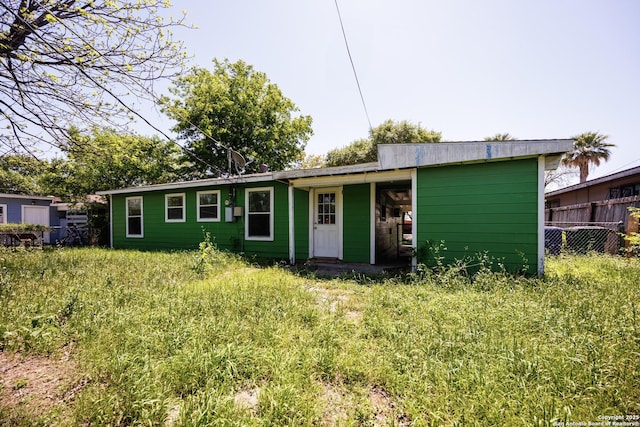 view of front of house featuring fence