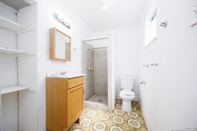 bathroom featuring vanity, toilet, and a stall shower