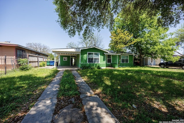 view of front of property featuring fence, a front lawn, driveway, and a carport