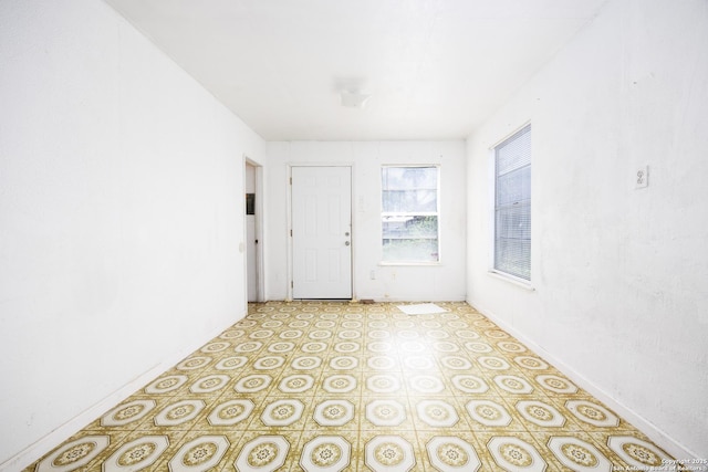 empty room with light floors and baseboards
