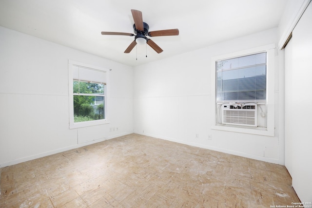 empty room with cooling unit and a ceiling fan