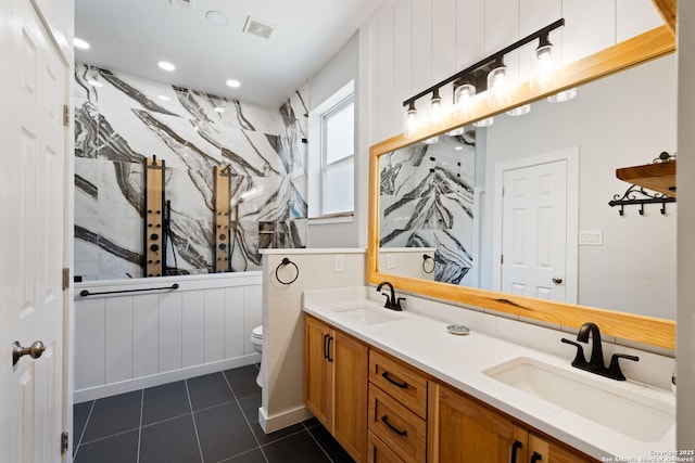 bathroom featuring tile patterned flooring, visible vents, a sink, and toilet