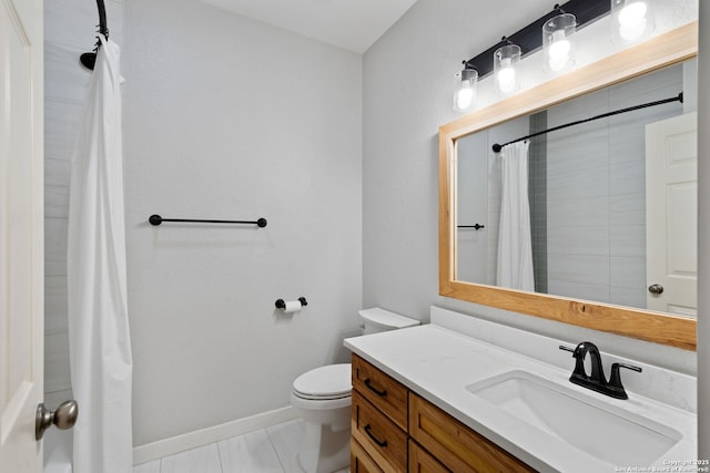 bathroom featuring baseboards, toilet, vanity, and a shower with shower curtain