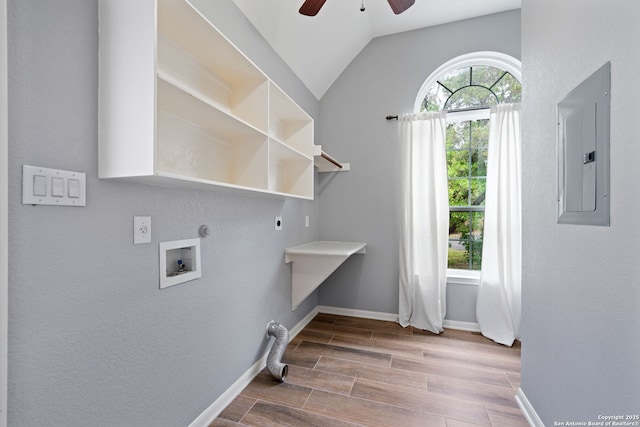 washroom with electric panel, hookup for an electric dryer, hookup for a washing machine, a ceiling fan, and laundry area