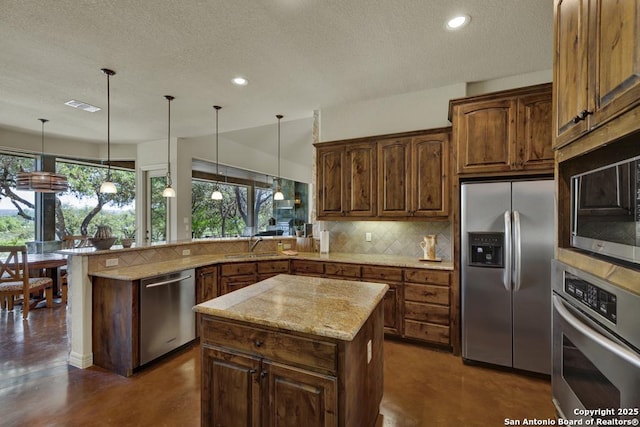 kitchen with stainless steel appliances, a peninsula, a textured ceiling, and tasteful backsplash