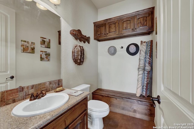 bathroom featuring toilet and vanity