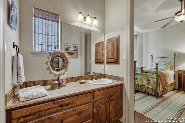 ensuite bathroom featuring ensuite bath, vanity, and ceiling fan