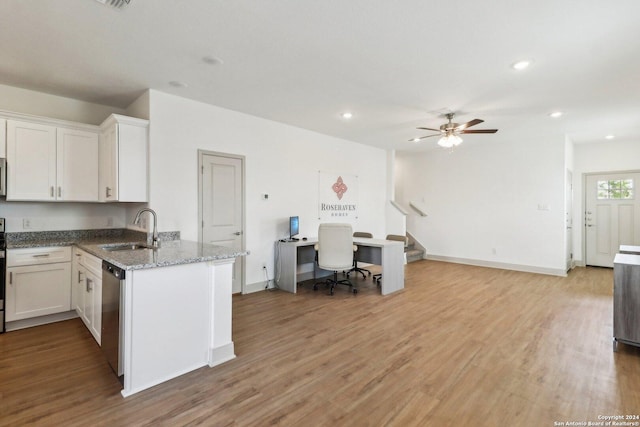 kitchen with recessed lighting, stainless steel dishwasher, white cabinetry, and a sink
