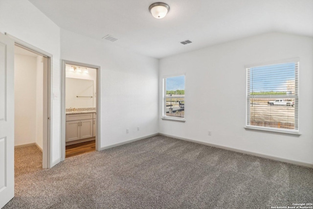 unfurnished bedroom featuring baseboards, visible vents, and carpet