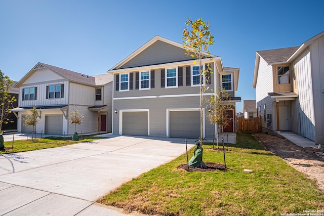 view of front facade with an attached garage, a front lawn, fence, and concrete driveway