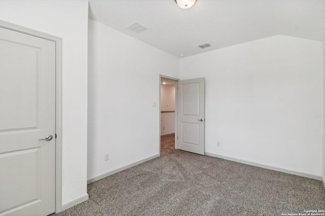 unfurnished bedroom featuring baseboards, visible vents, and carpet