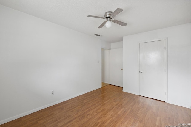 5822 Bennington, San Antonio, TX 78228 - unfurnished bedroom with ceiling fan, baseboards, wood finished floors, and visible vents