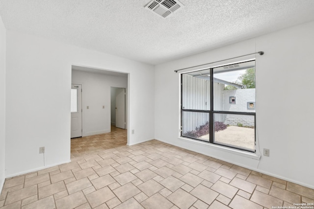 5822 Bennington, San Antonio, TX 78228 - spare room with a textured ceiling, visible vents, and baseboards