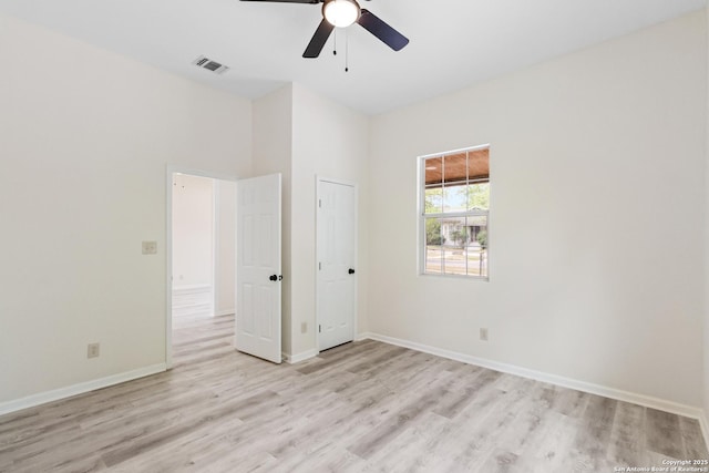 unfurnished bedroom featuring baseboards, visible vents, light wood-style floors, and ceiling fan