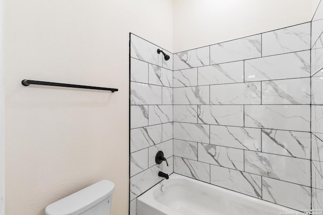 bathroom featuring shower / tub combination and toilet