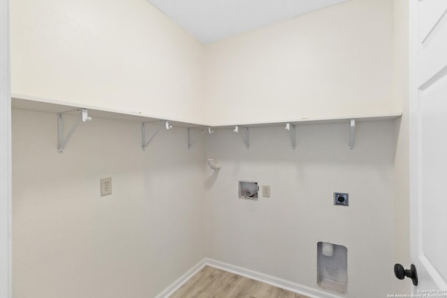 clothes washing area featuring hookup for an electric dryer, baseboards, light wood-style floors, hookup for a washing machine, and laundry area
