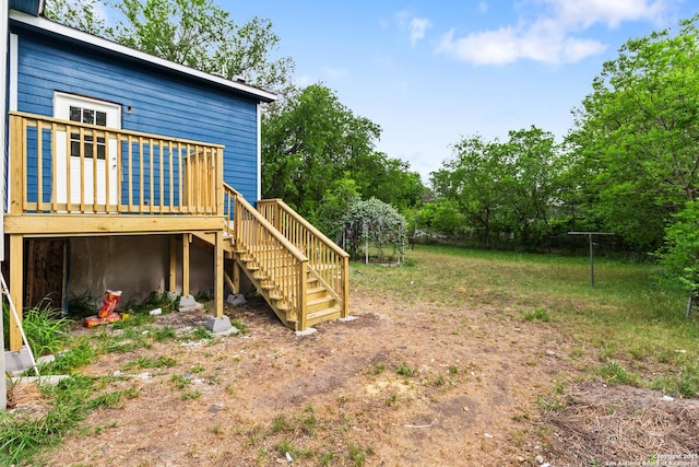 view of yard with stairway, fence, and a deck