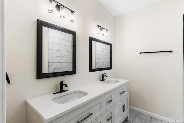 238 Cooper, San Antonio, TX 78210 - bathroom with double vanity, marble finish flooring, and baseboards