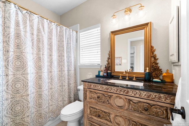 bathroom with curtained shower, toilet, and vanity