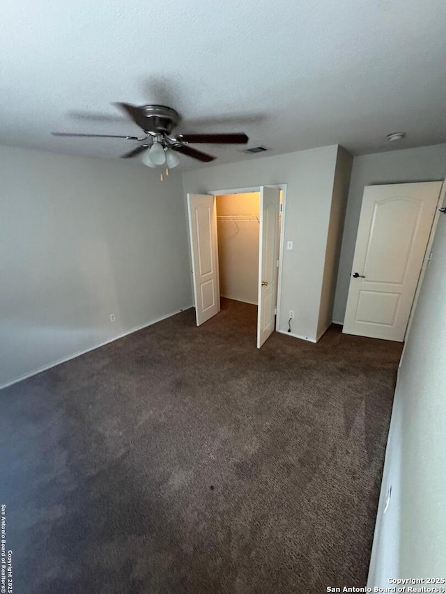 791 Sycamore Moon, San Antonio, TX 78216 - unfurnished bedroom with dark colored carpet, visible vents, a closet, and a ceiling fan
