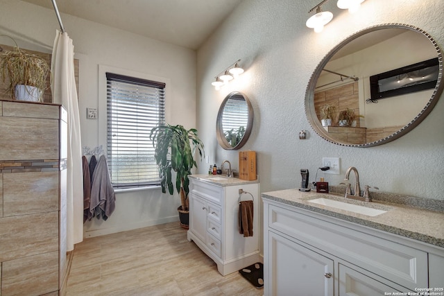 1340 Hinch, New Braunfels, TX 78132 - full bathroom featuring two vanities, baseboards, a shower with curtain, and a sink
