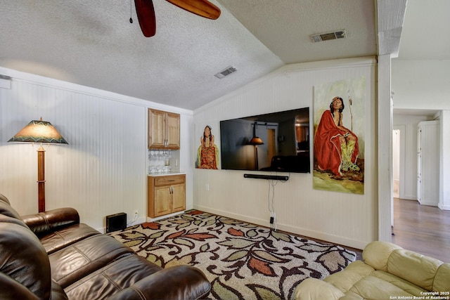 1340 Hinch, New Braunfels, TX 78132 - living area featuring vaulted ceiling, visible vents, baseboards, a textured ceiling, and ceiling fan
