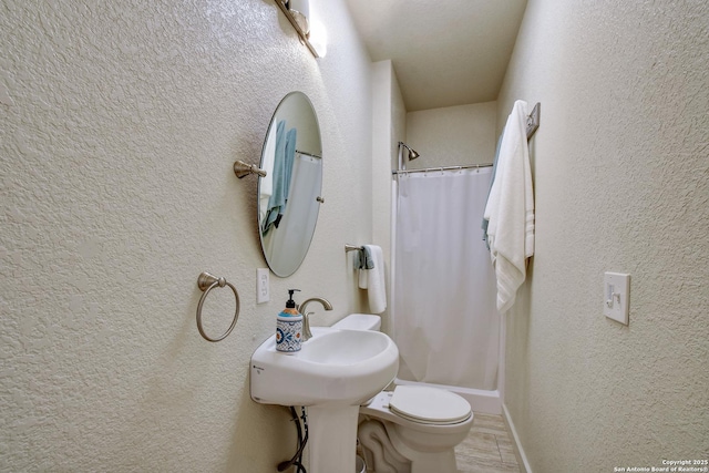 1340 Hinch, New Braunfels, TX 78132 - bathroom with a textured wall, a shower with curtain, and toilet